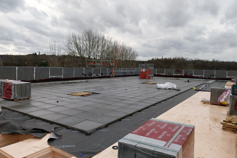Grey flagstones on the flat roof of a building