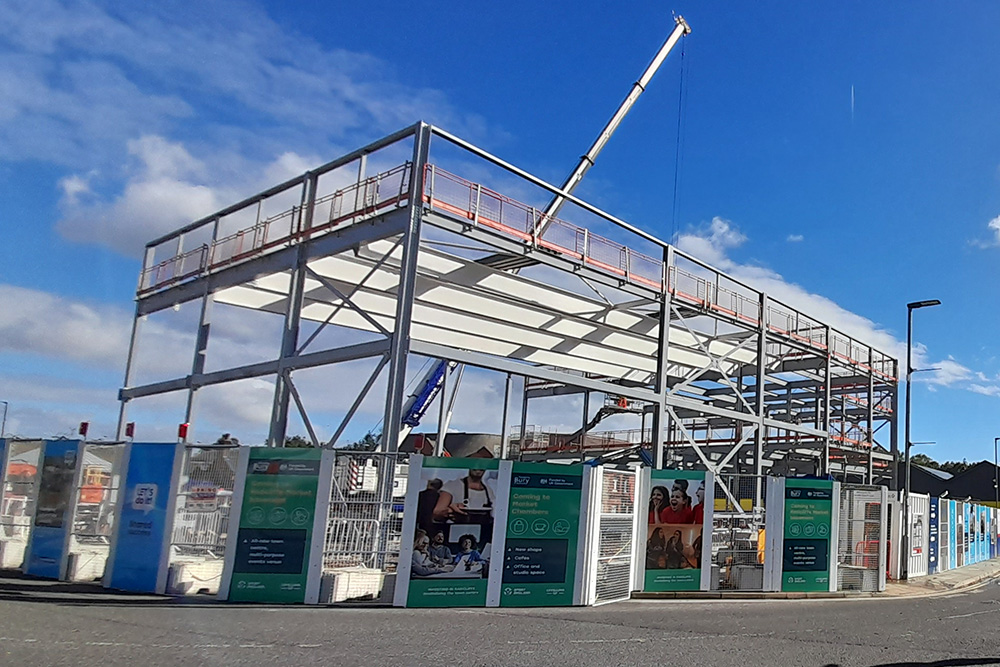Steel building frame and a crane on a construction site