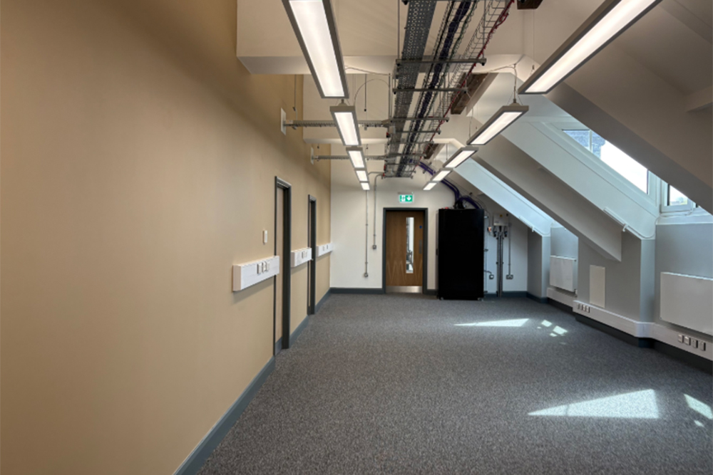 A large empty room with a sloping roof on one side