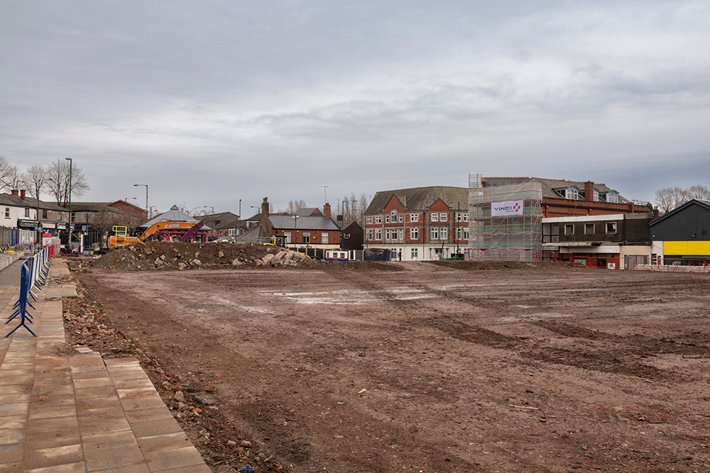 An empty piece of land surrounded by buildings
