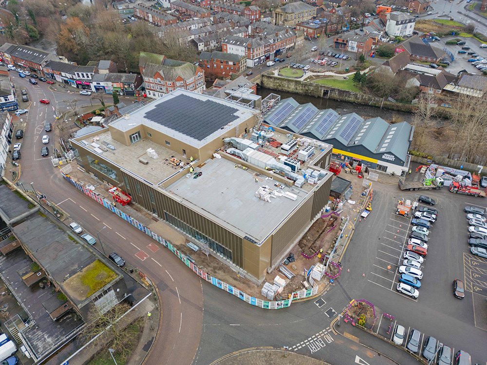 A birds-eye view of a large building on a construction site in a town centre