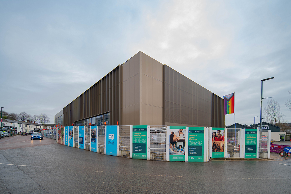 A large building surrounded by hoarding panels