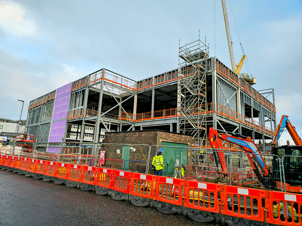 Steel building frame and a crane on a construction site