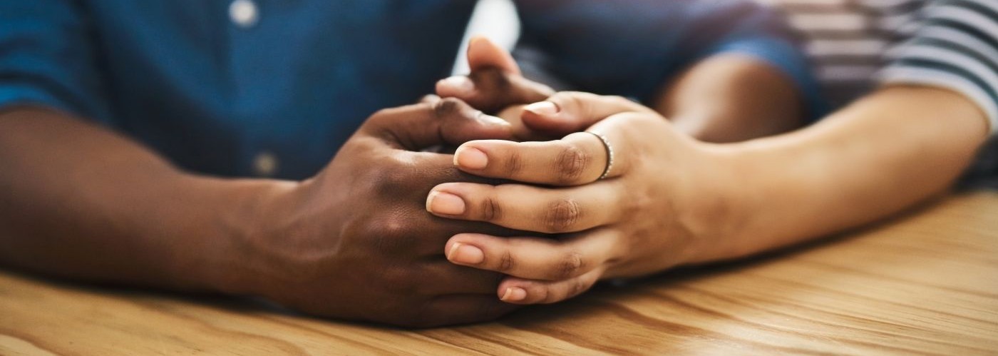 two people holding hands in a supportive way