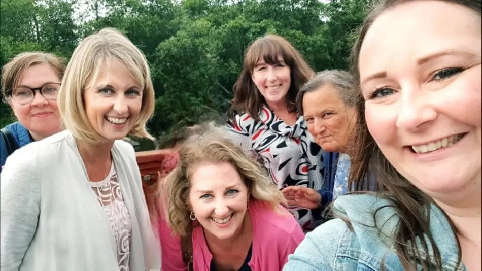 A group of women smiling into the camera.