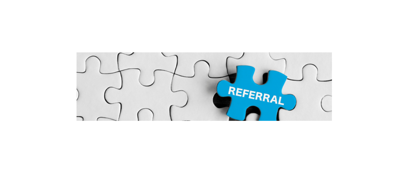 A white jigsaw puzzle with one blue piece with referral written on it