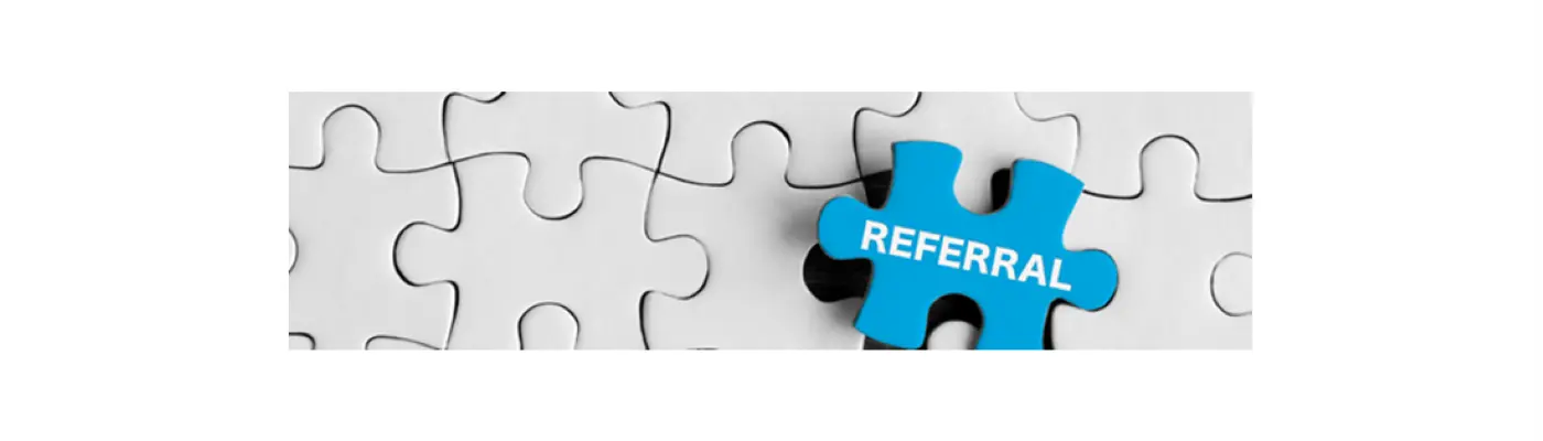 A white jigsaw puzzle with one blue piece with referral written on it