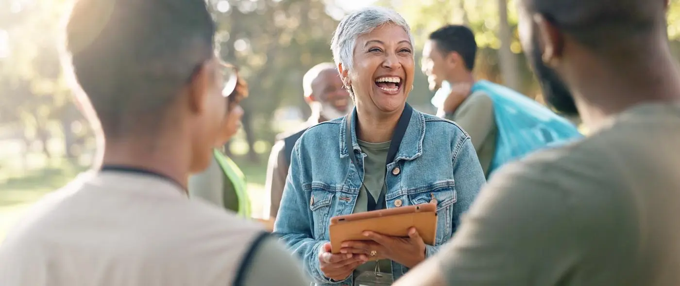 Woman with volunteer badge laughing