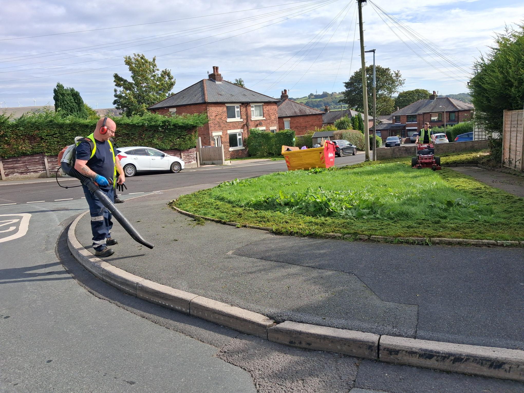 caretakers clearing leaves