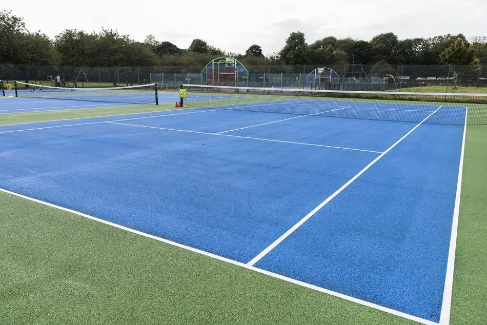 Blue surfaced tennis court and nets at St Mary's Park, Prestwich.