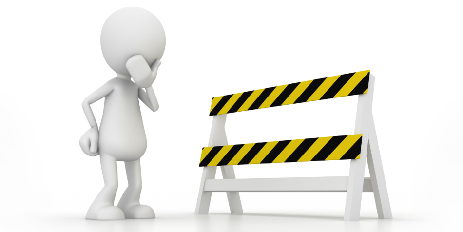 A person looking at a road barrier pensively