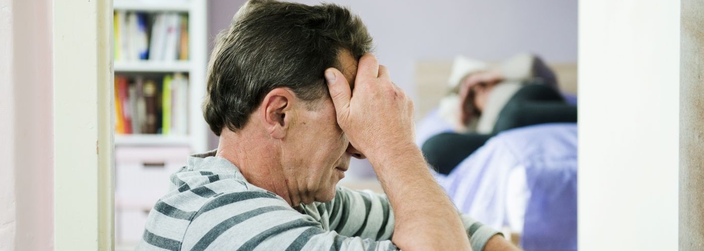 A man holding his head in his hands