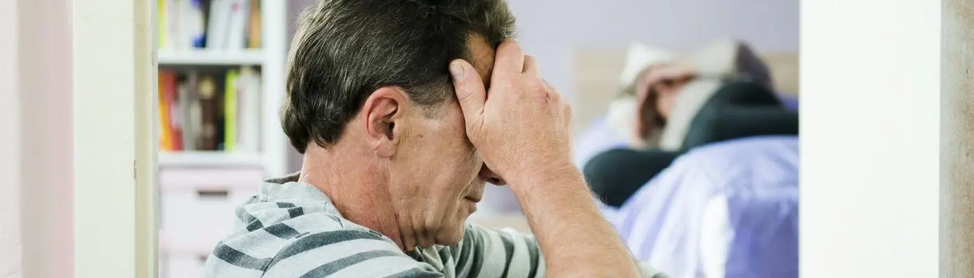 A man holding his head in his hands