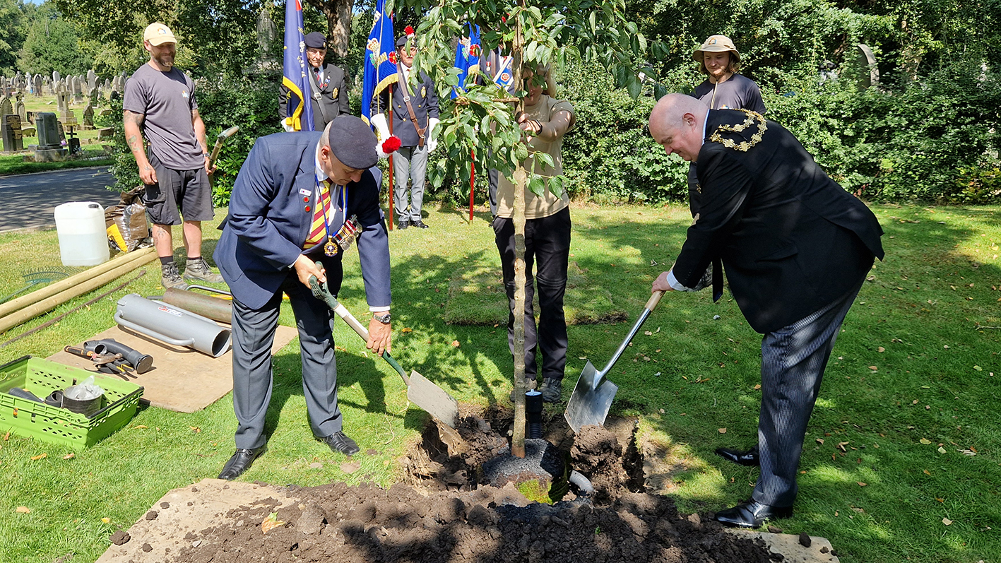 The Mayor of Bury, Cllr Noel Bayley, and veterans planting memorial trees at Bury cemetery