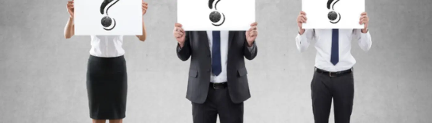 three people holding question marks in front of their faces