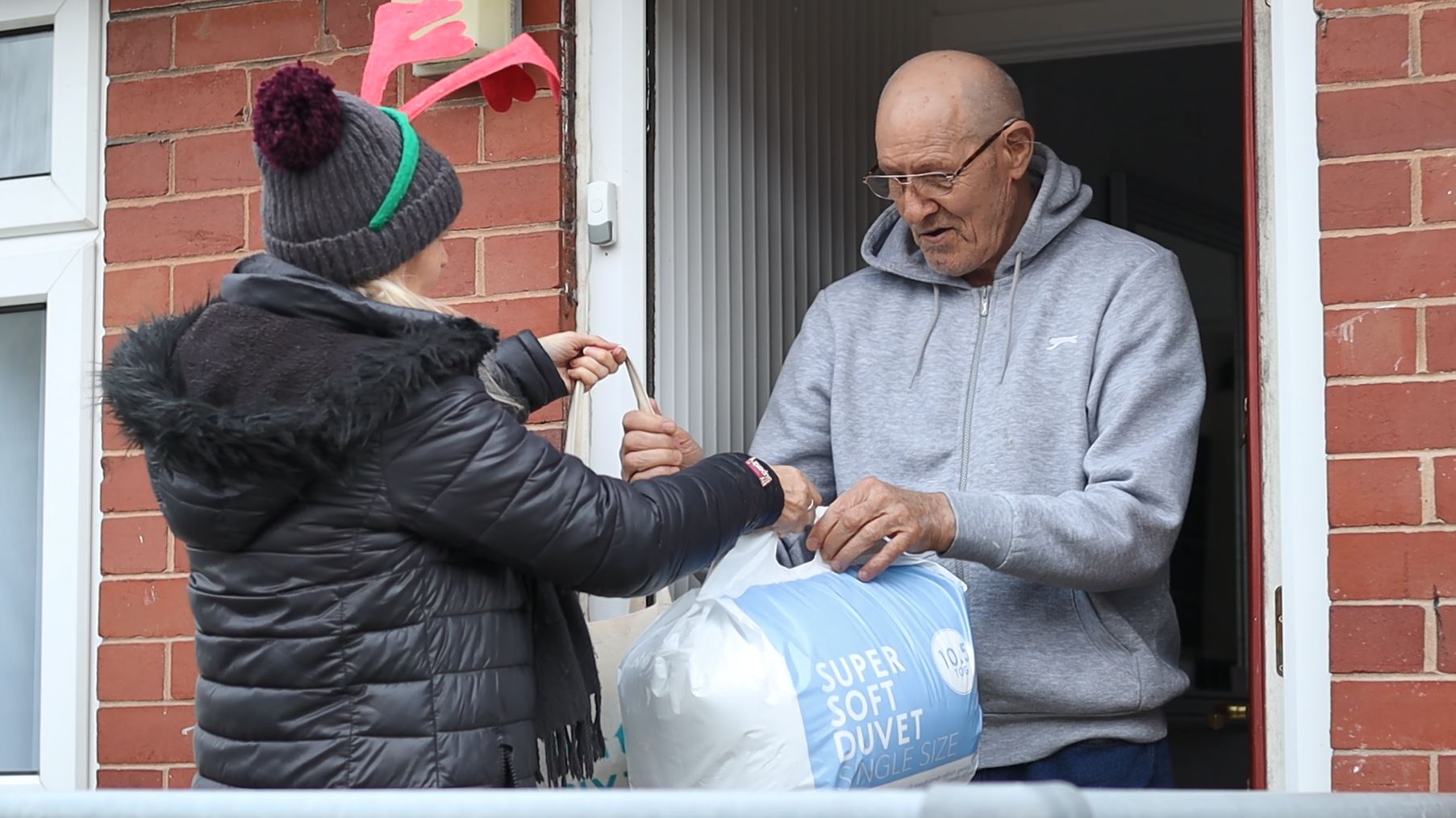 tenants being handing a winter warmer pack 