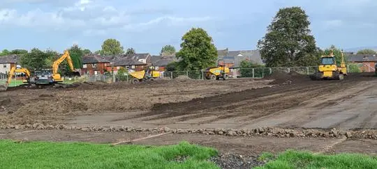 Bulldozers digging up a field
