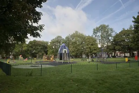 Climbing frame and swings in a play area.