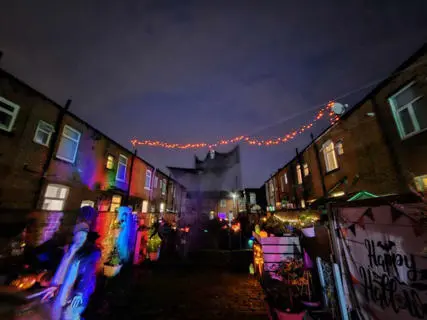 A back alley lit up with coloured lights