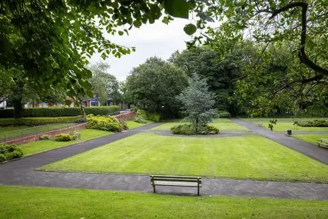 Footpaths, bench, gardens, bushes and trees at Hamilton Rd Park.