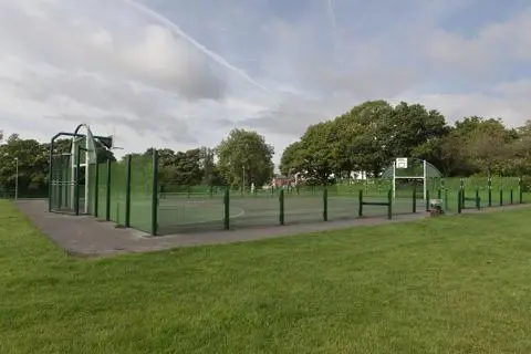 Courted multi-ball play area surrounded by grass.